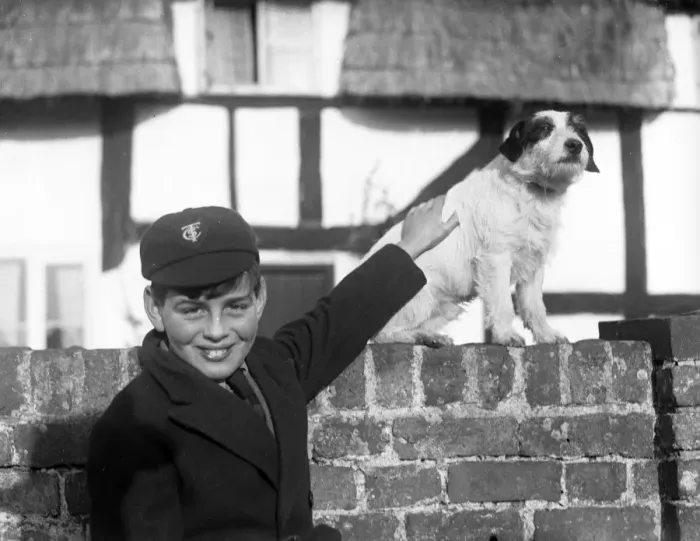 Framed Print : A smiling schoolboy and his terrier dog Framed Print : A smiling schoolboy and his terrier dog