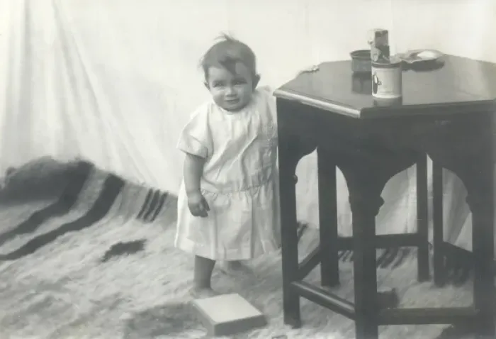 Framed Print : Smiling toddler leaning against a table Framed Print : Smiling toddler leaning against a table