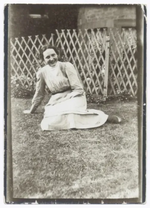 Framed Print : Smiling woman sitting on a lawn Framed Print : Smiling woman sitting on a lawn