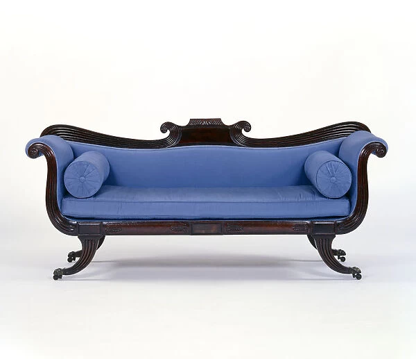Sofa with a mahogany frame on reeded sabre legs with brass paw caps