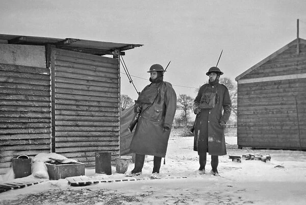 Two soldiers at a camp in winter