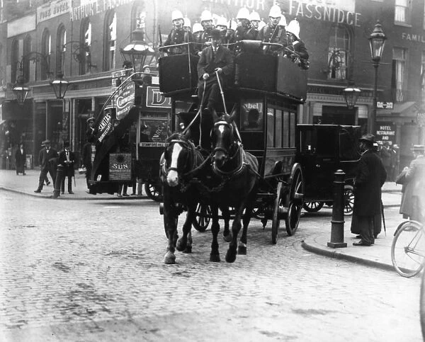 Soldiers riding on the top deck of a London omnibus