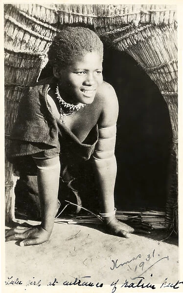 South Africa - smiling Zulu girl kneeling in her doorway
