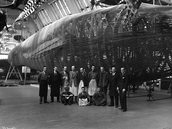 Staff posing with blue whale model, 1938