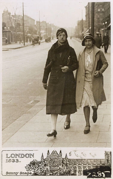 A stern pair of Ladies stride down a London Street