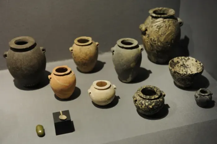Framed Print : Stone jars and bowls with a small spoon and a small grinding Framed Print : Stone jars and bowls with a small spoon and a small grinding