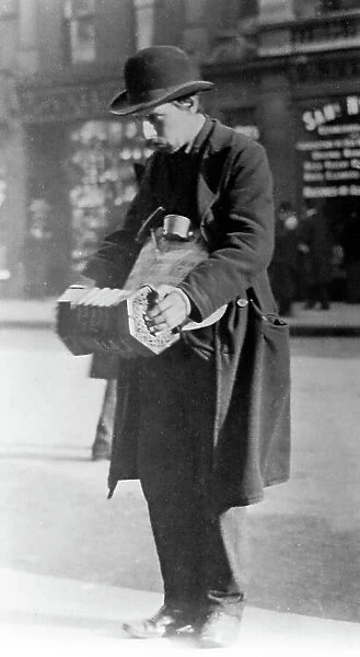 Street musician, London, early 1900s