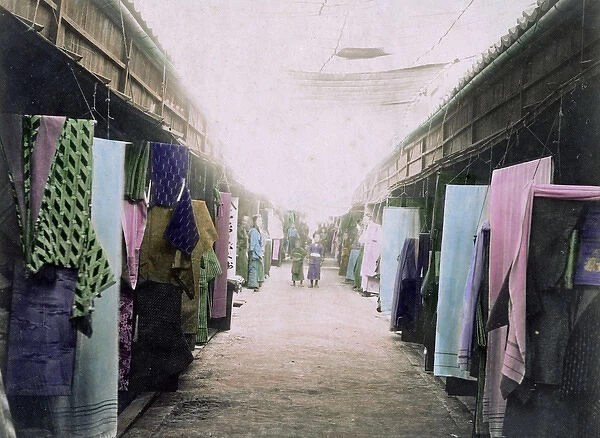 Street of shops selling clothes and material, Japan, circa 1
