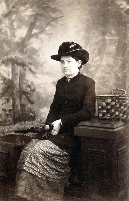 Framed Print : Studio photo, Seated woman with painted backdrop Framed Print : Studio photo, Seated woman with painted backdrop