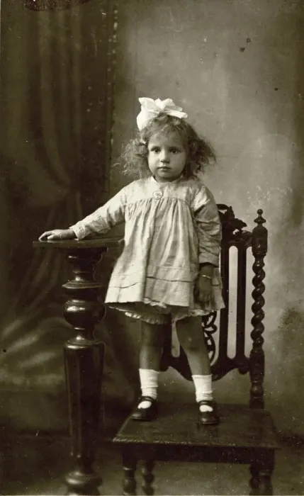 Framed Print : Studio photo of young girl standing on a chair Framed Print : Studio photo of young girl standing on a chair