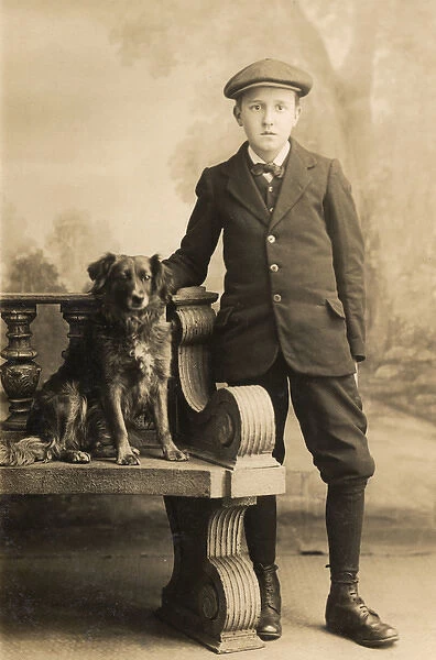 Studio portrait, boy with a dog