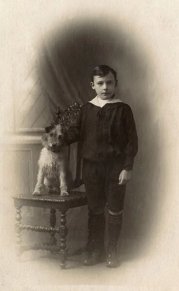 Studio portrait, boy with terrier dog