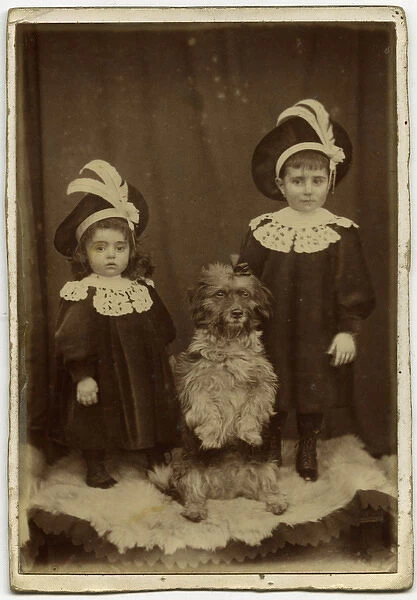 Studio portrait, two children with dog