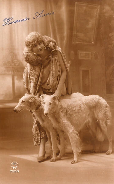 Studio portrait, elegant woman with two dogs, France