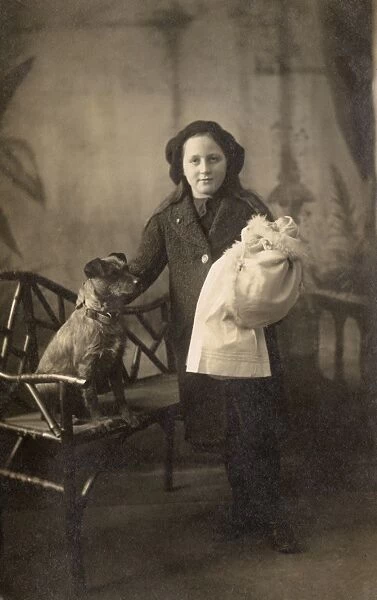 Studio portrait, girl with dog and doll