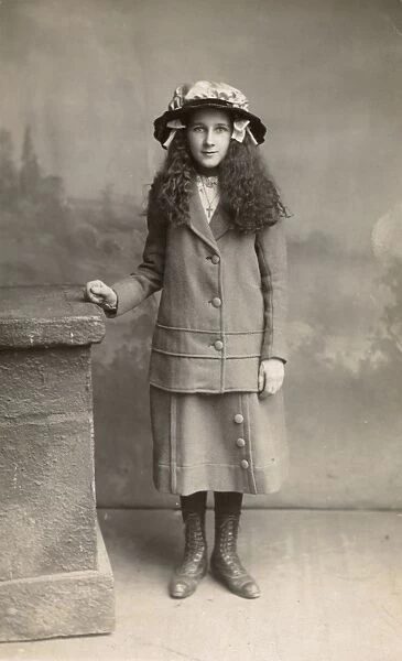 Studio portrait, girl in suit and hat