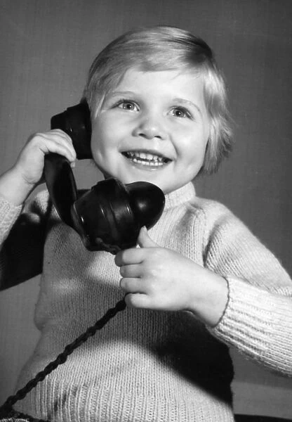 Studio portrait, little boy on the phone