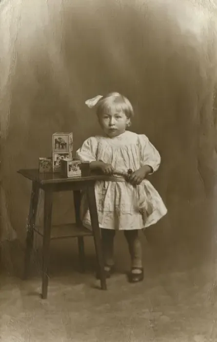 Framed Print : Studio portrait, little girl with table and toy bricks Framed Print : Studio portrait, little girl with table and toy bricks