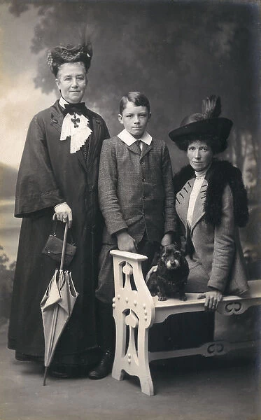 Studio portrait, three people with small terrier dog