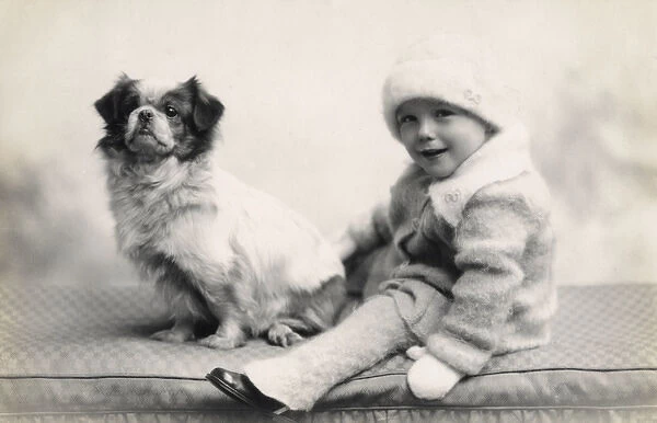Studio portrait of toddler and dog