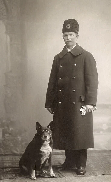 Studio portrait, uniformed man with dog