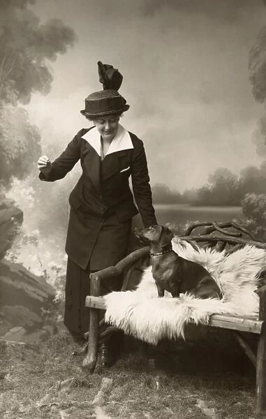 Studio portrait, woman with dachshund
