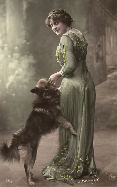 Studio portrait, woman in green dress with dog