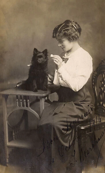 Studio portrait, woman with Pomeranian dog