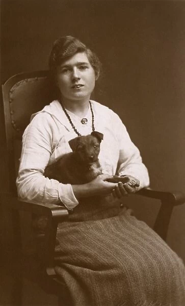 Studio portrait, woman with puppy