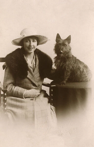 Studio portrait, woman with Scots terrier