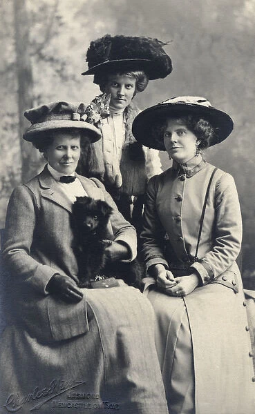 Studio portrait, three women with a dog