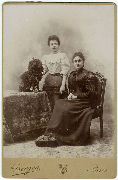 Studio portrait, two women with poodle dog
