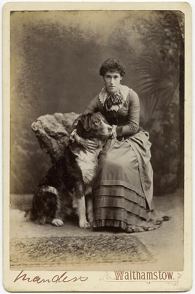 Studio portrait, young woman with large dog