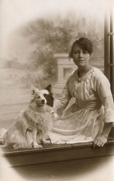Studio portrait, young woman with little dog