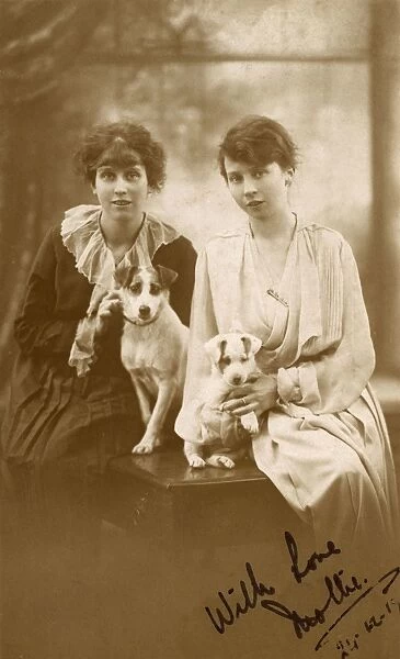 Studio portrait, two young women with dog and puppy