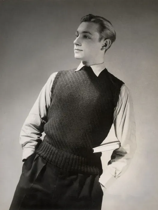 Framed Print : A studious young man with a book under his arm wears a vest or sleeveless knitted top in a stitch that produces a decorative diagonal stripe. Date: 1950's Framed Print : A studious young man with a book under his arm wears a vest or sleeveless knitted top in a stitch that produces a decorative diagonal stripe. Date: 1950's