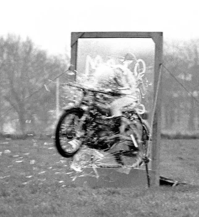 Framed Print : Stunt woman rides her motorbike through a glass plate, shattering it as she speeds through. Date: circa 1970s Framed Print : Stunt woman rides her motorbike through a glass plate, shattering it as she speeds through. Date: circa 1970s