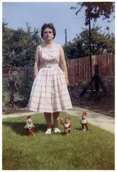 Suburban garden scene - lady and garden gnomes