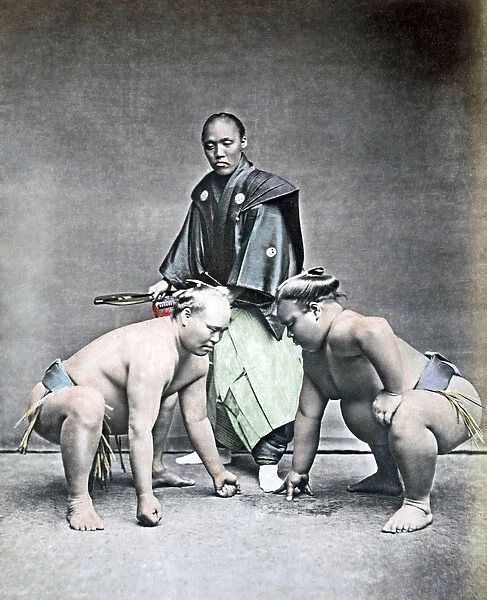 Sumo wrestlers and referee, Japan, 1870s