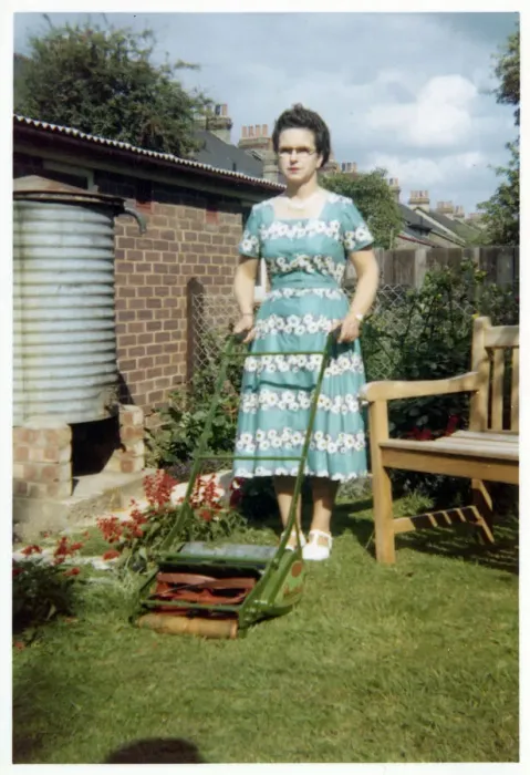 Framed Print : Surburban garden scene - lady and lawnmower Framed Print : Surburban garden scene - lady and lawnmower