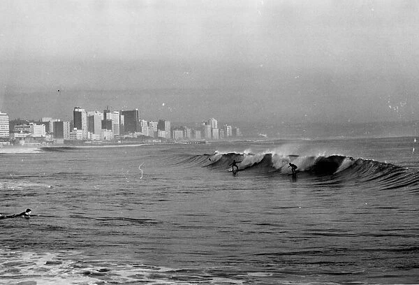 Surfing at Durban, South Africa. Date: late 1960s