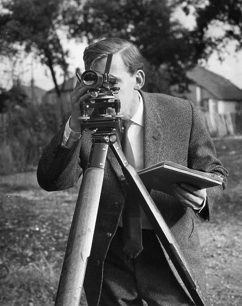 Surveyor at work with a theodolite