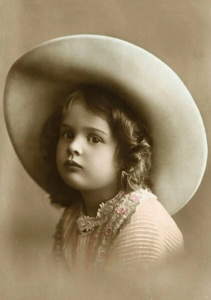 A sweet little girl wearing a wide-brimmed hat