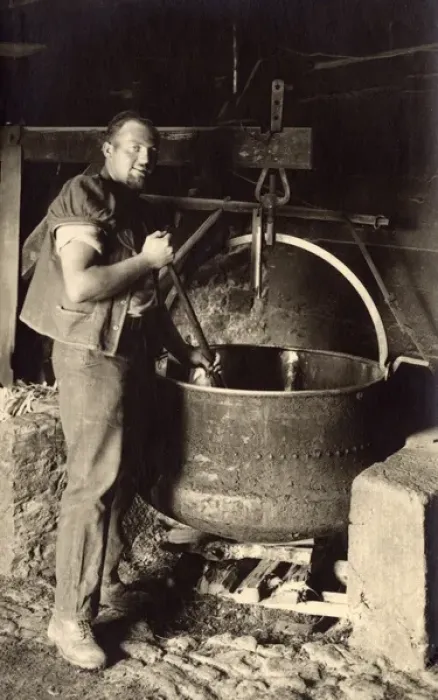 Framed Print : Swiss Cheesemaker stiring a large vat Framed Print : Swiss Cheesemaker stiring a large vat