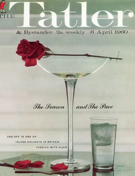 Framed Print : Tatler Front Cover - A wilting red rose is balanced on top of a nearly empty champagne glass, having shed a few petals onto the table Framed Print : Tatler Front Cover - A wilting red rose is balanced on top of a nearly empty champagne glass, having shed a few petals onto the table