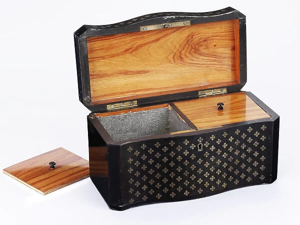 Tea caddy made from ebonised wood inlaid with brass quatrefoils, lined with tulipwood