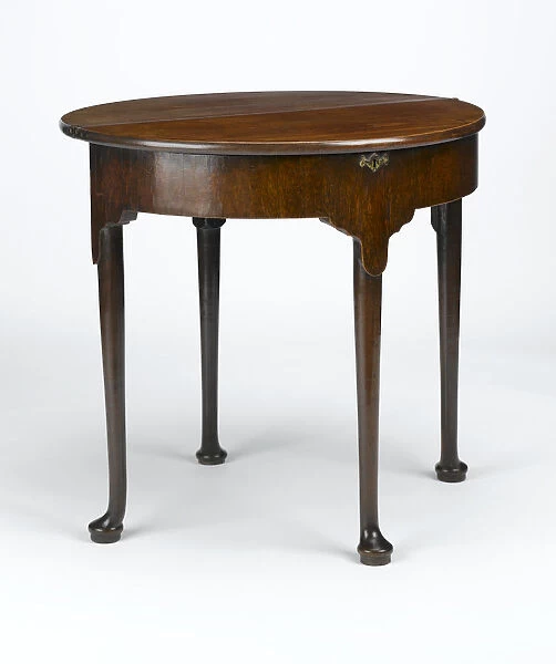 Tea table. Mahogany tea table with a folding half-round top, on turned