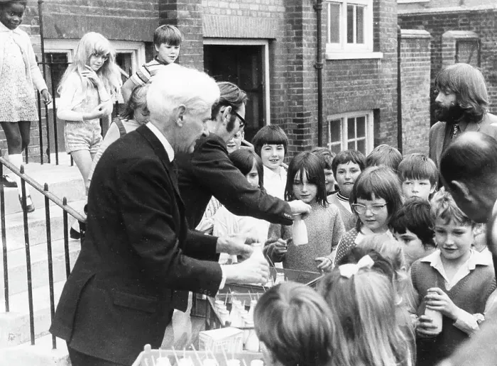 Framed Print : Teachers distributing milk to children, Woolwich, London Framed Print : Teachers distributing milk to children, Woolwich, London