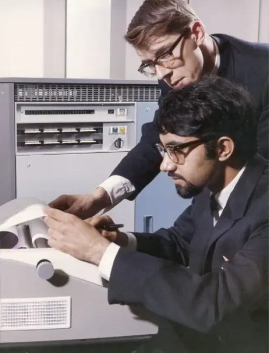 Framed Print : Two technicians check a computer printout Framed Print : Two technicians check a computer printout