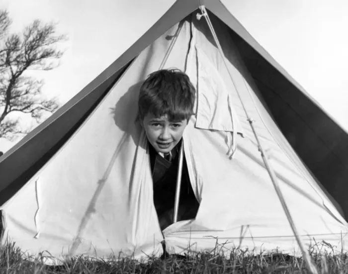 Framed Print : TENT BOY. A little boy peeping out of a tent! Date: 1960s Framed Print : TENT BOY. A little boy peeping out of a tent! Date: 1960s